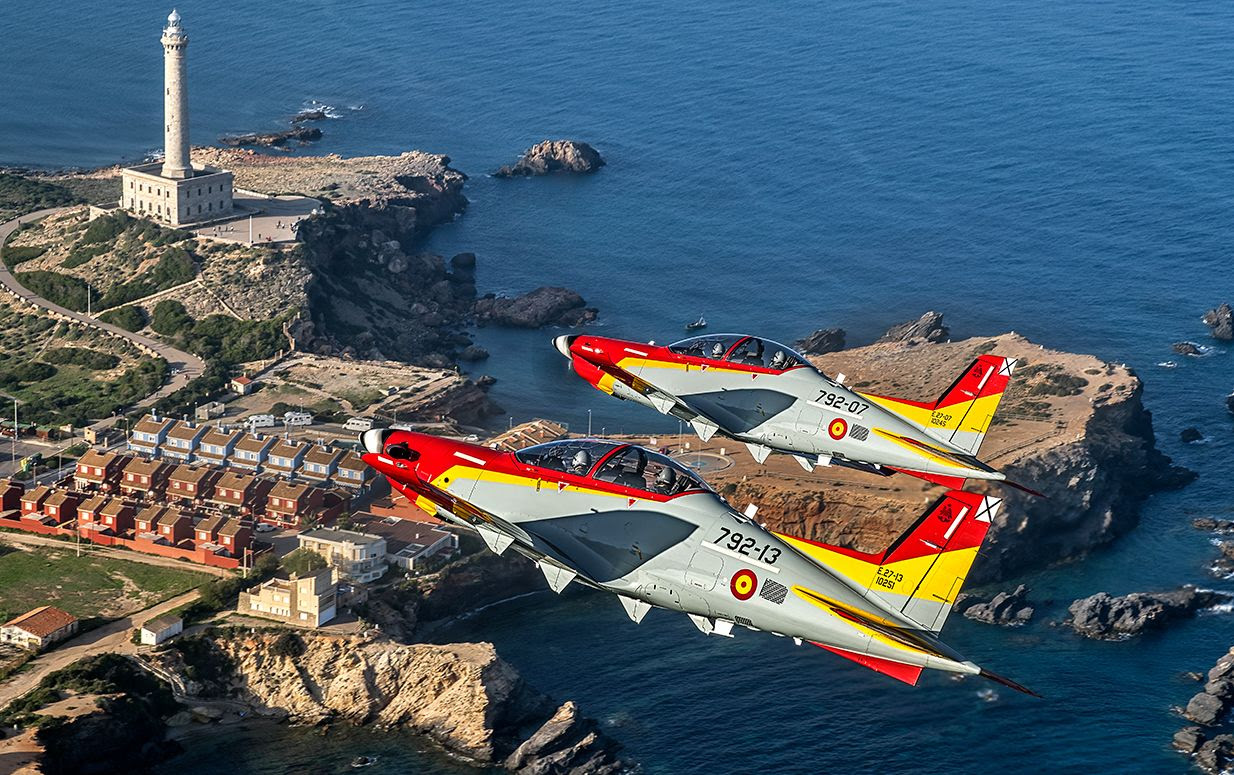 Two Spanish Air Force Pilatus PC-21 trainers in formation over the coast.