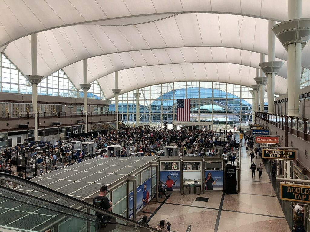 A crowd of passengers at the security area in Denver International Airport.