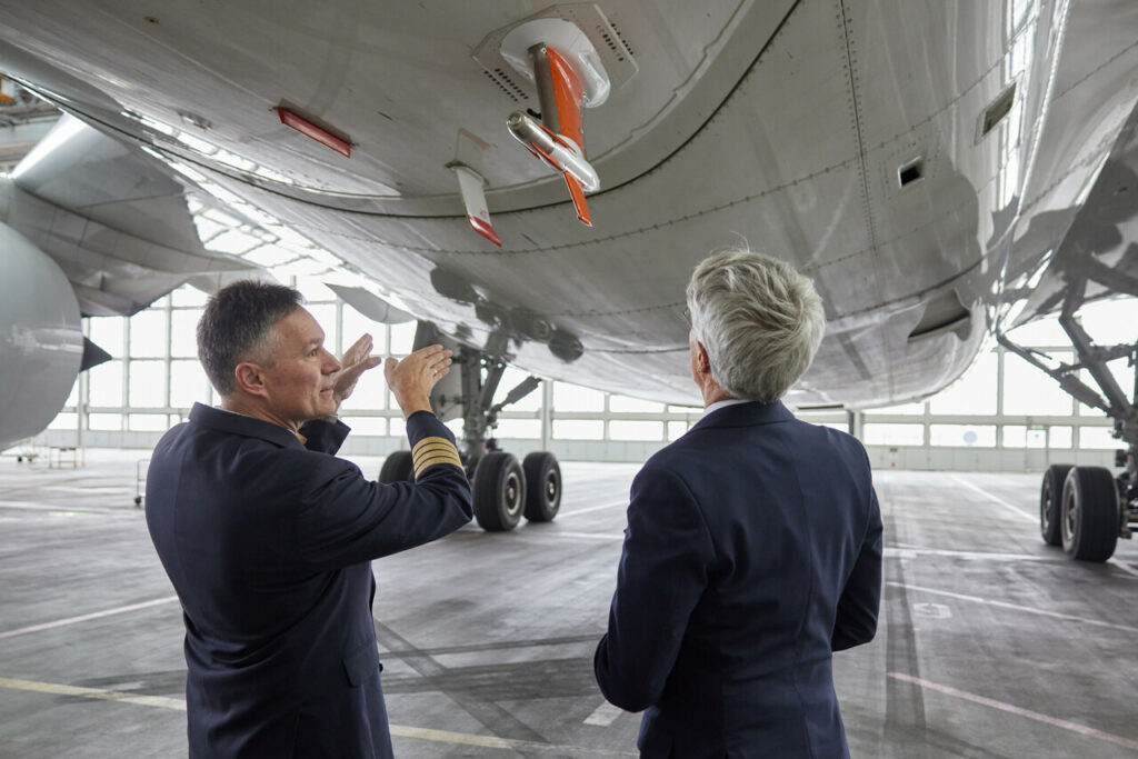 Lufthansa management staff view research equipment on the underside of an Airbus A350