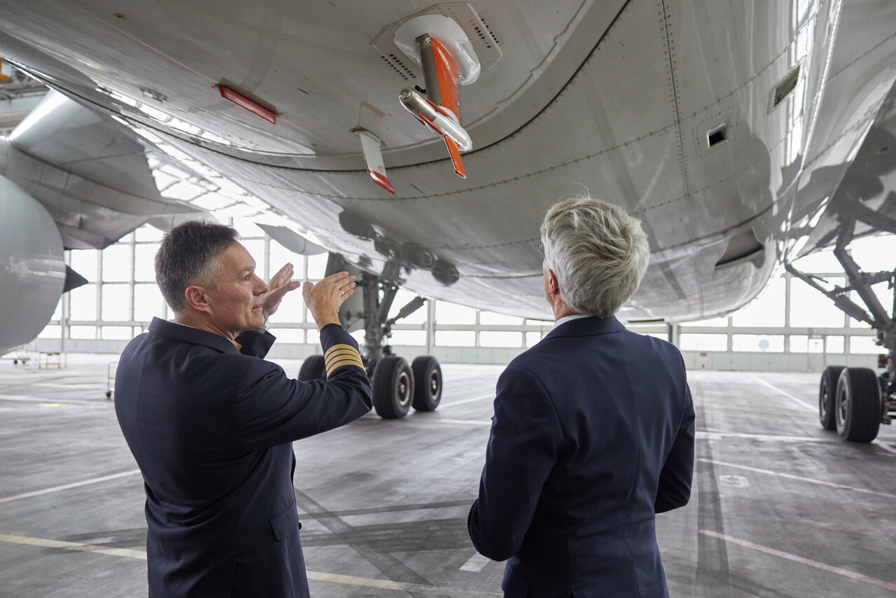 Lufthansa management staff view research equipment on the underside of an Airbus A350