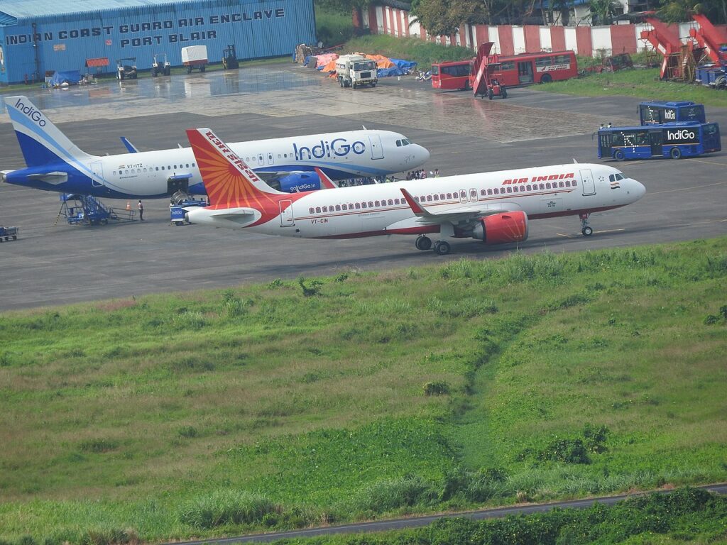 Air India and IndiGo aircraft parked together at airport.