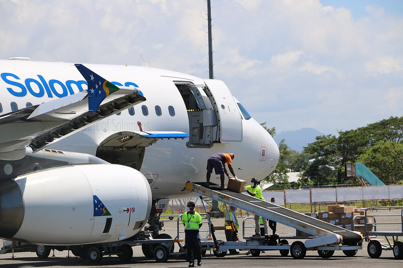 Baggage is unloaded from a Solomon Airlines aircraft.
