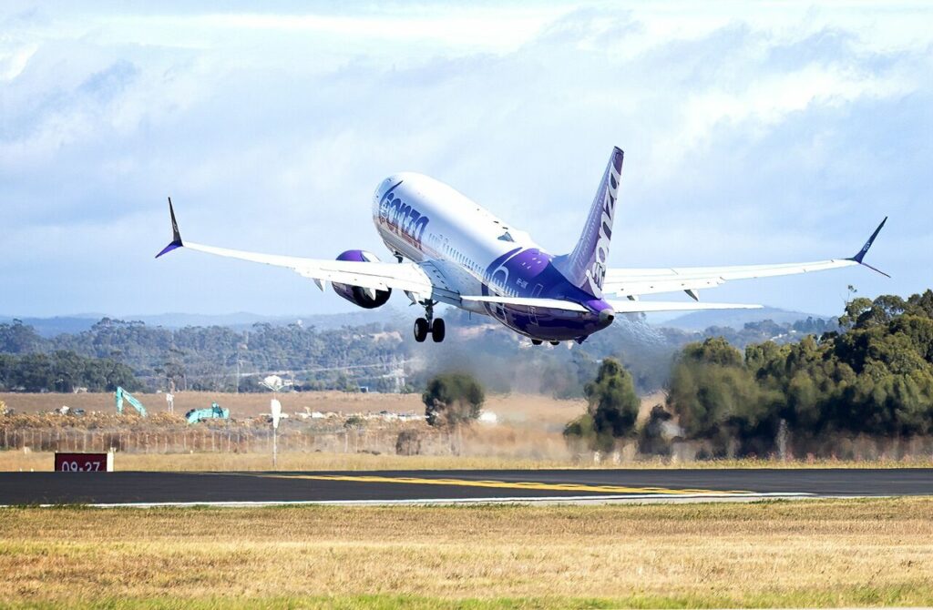 A Bonza Boeing 737 climbs out after takeoff.
