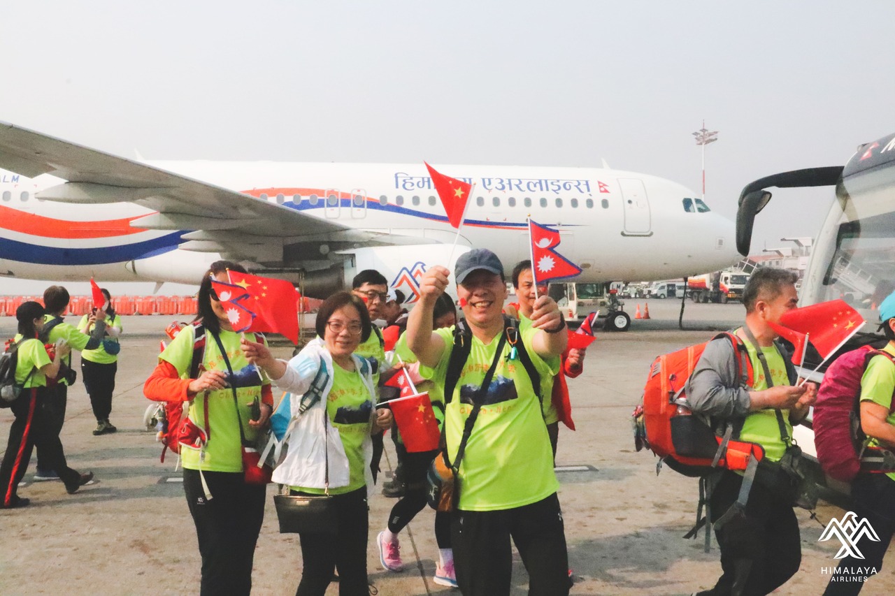 Chinese tourists disembark a Himalaya Airlines charter flight.