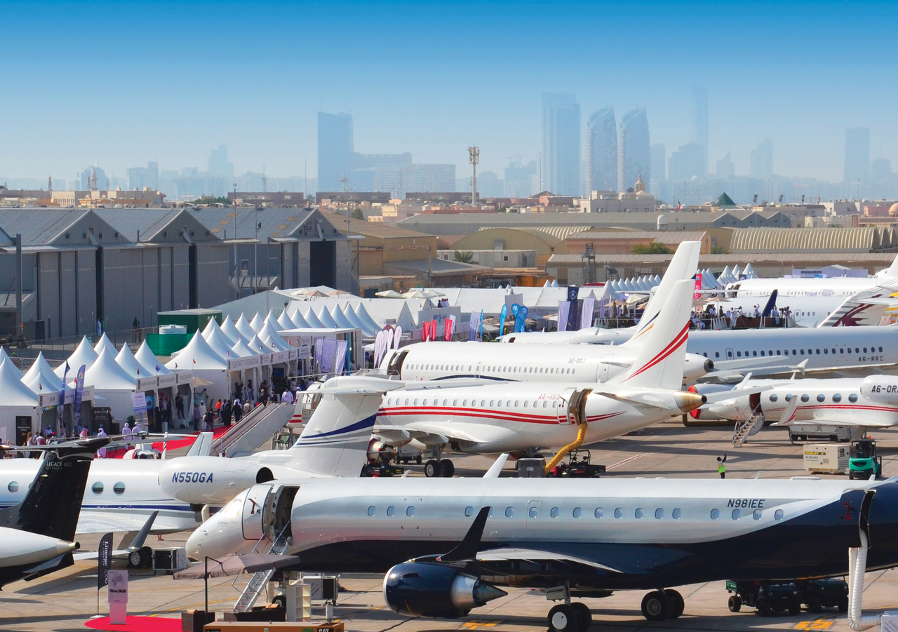 Airshow exhibition with parked aircraft.