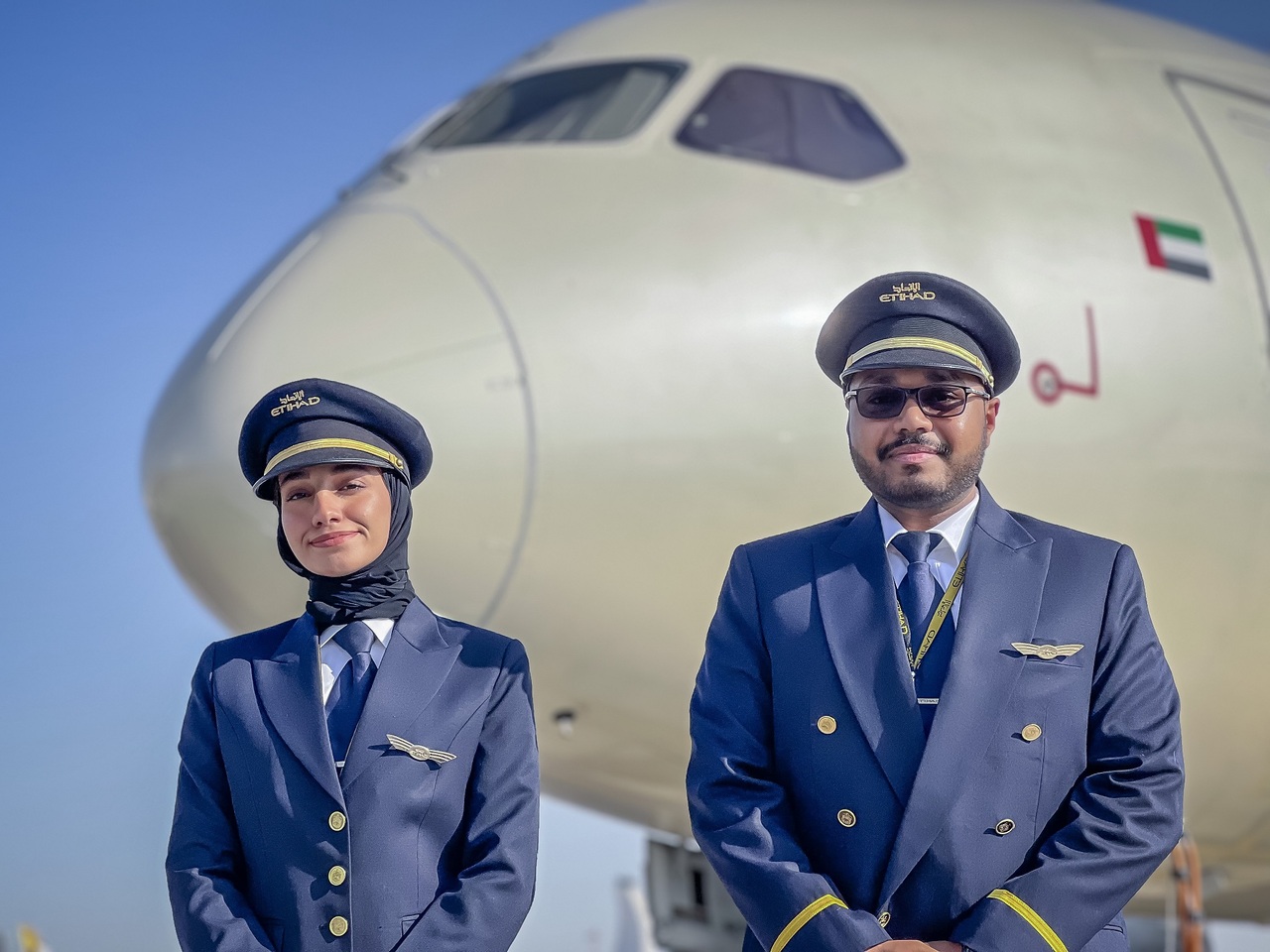 Etihad Airways cadet pilots pose in front of Etihad aircraft.