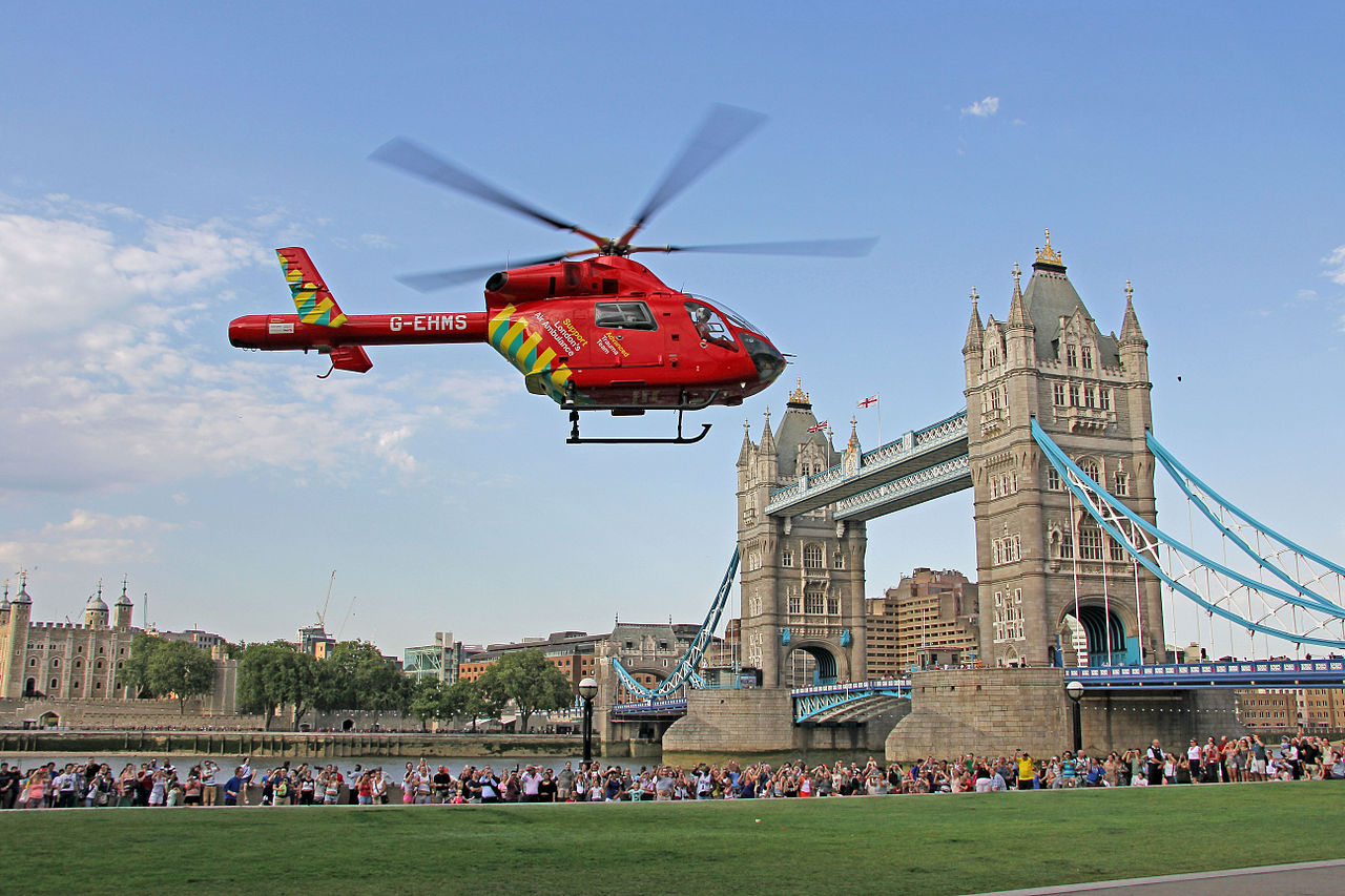 A London Air Ambulance helicopter flies near the Tower Bridge
