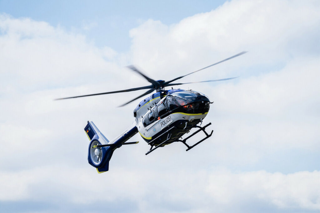A Bavarian Police Airbus H145 helicopter hovering.