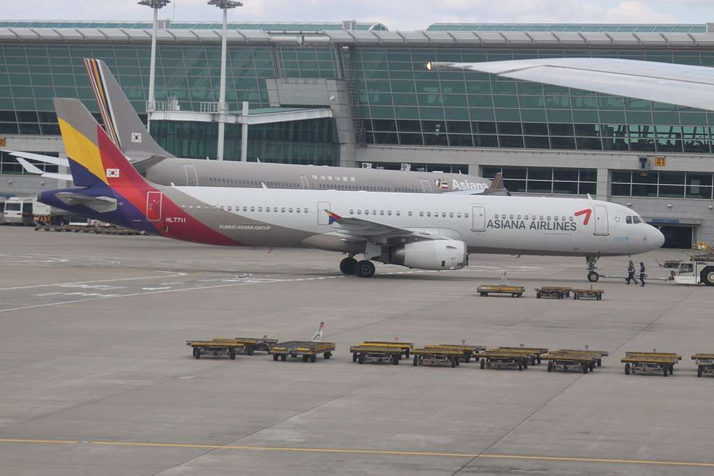 An Asiana Airlines A321 parked at the terminal.