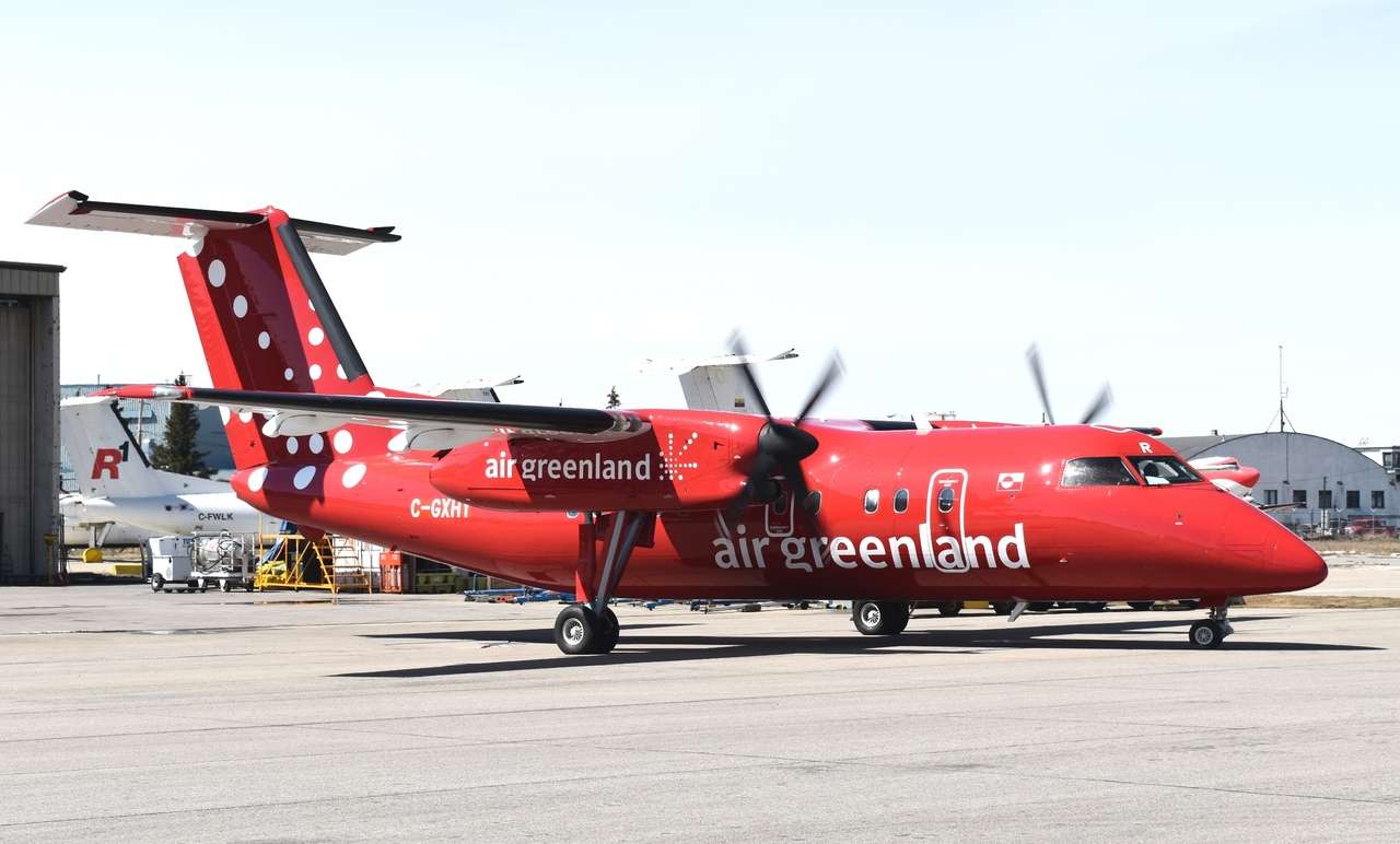 A new Air Greenland DHC Dash 8 parked on the tarmac.