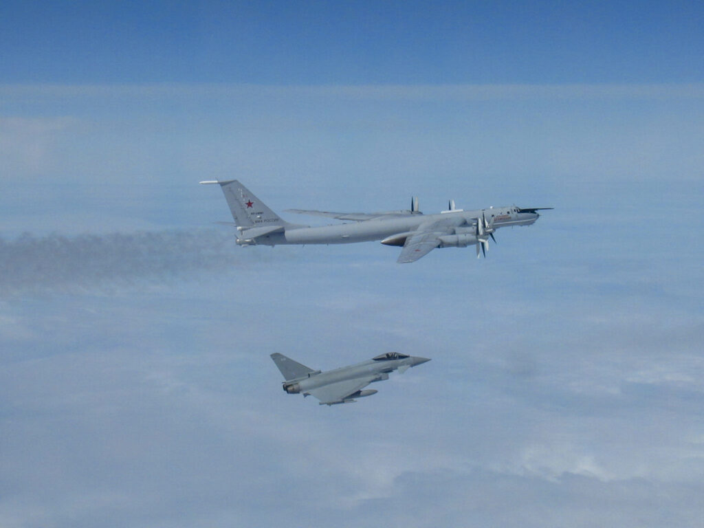 A RAF Typohhon escorts a Russian Tu-142 surveillance aircraft.