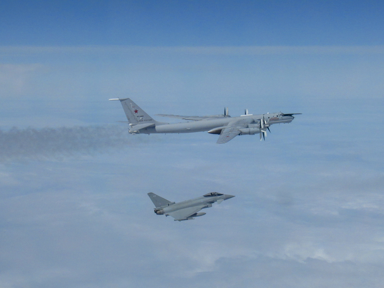 A RAF Typohhon escorts a Russian Tu-142 surveillance aircraft.