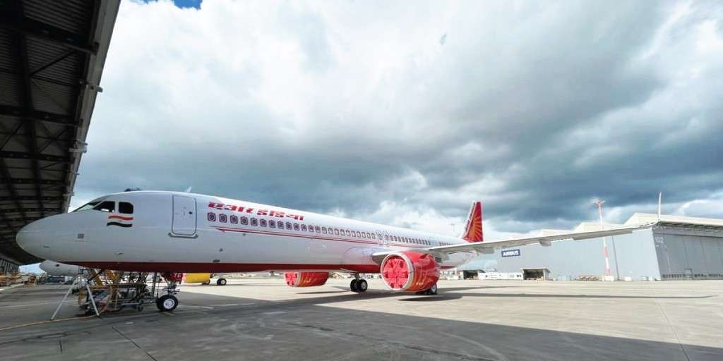 An Air India Airbus A3210neo in front of the hangar.