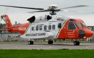 An Irish Coast Guard Sikorsky helicopter prepares for takeoff.