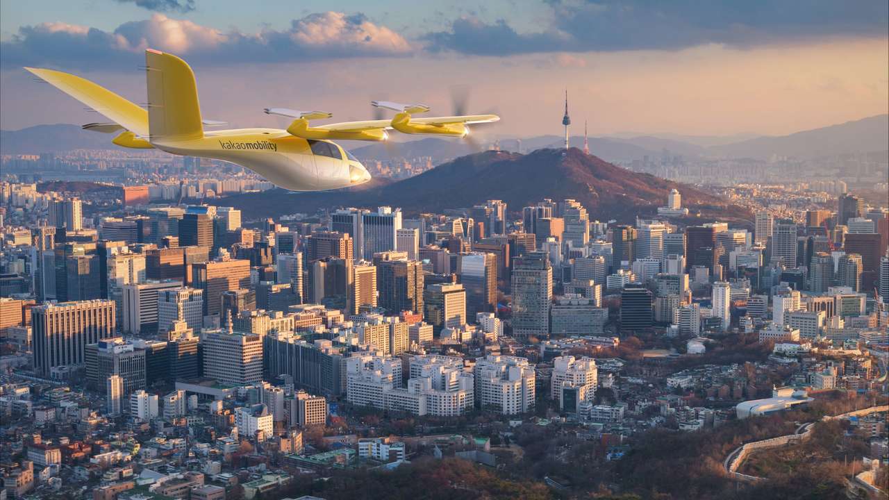 Render of a Kakao Mobility Vertical Aerospace VX4 in flight over Seoul.