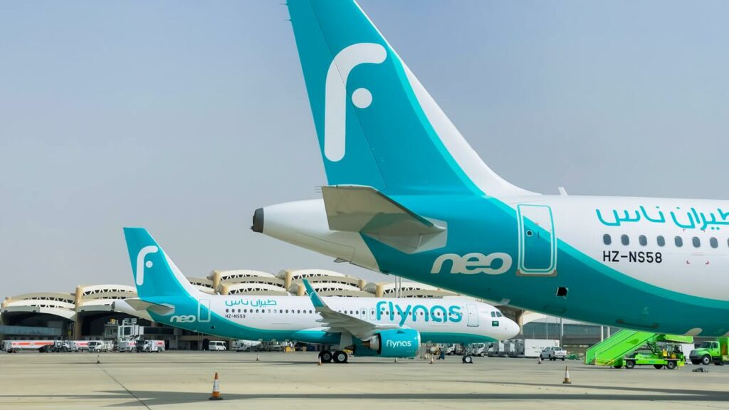 Two new flynas Airbus A320neos parked together on the ramp.