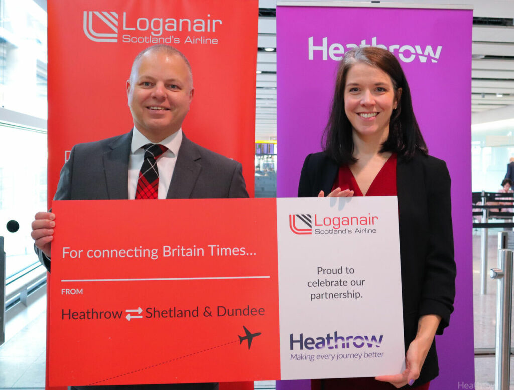 Loganair and Heathrow management staff display banners at Heathrow Airport.