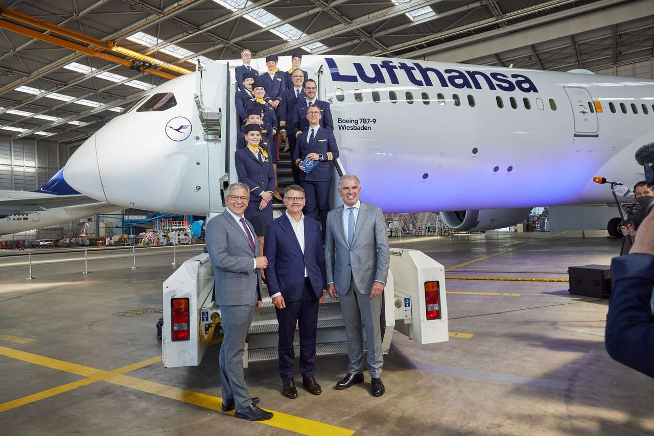 Lufthansa officials with Boeing 787-9 Dreamliner in the hangar.