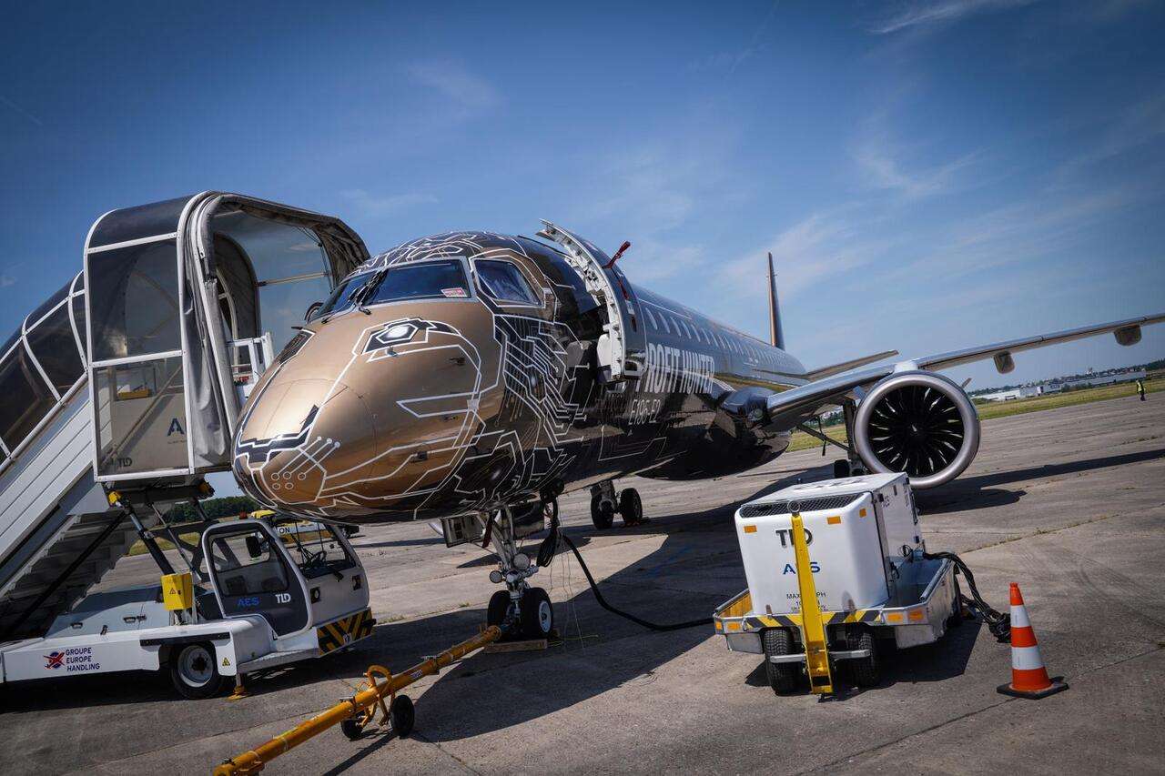 An Embraer E195-E2 jet parked on the tarmac.