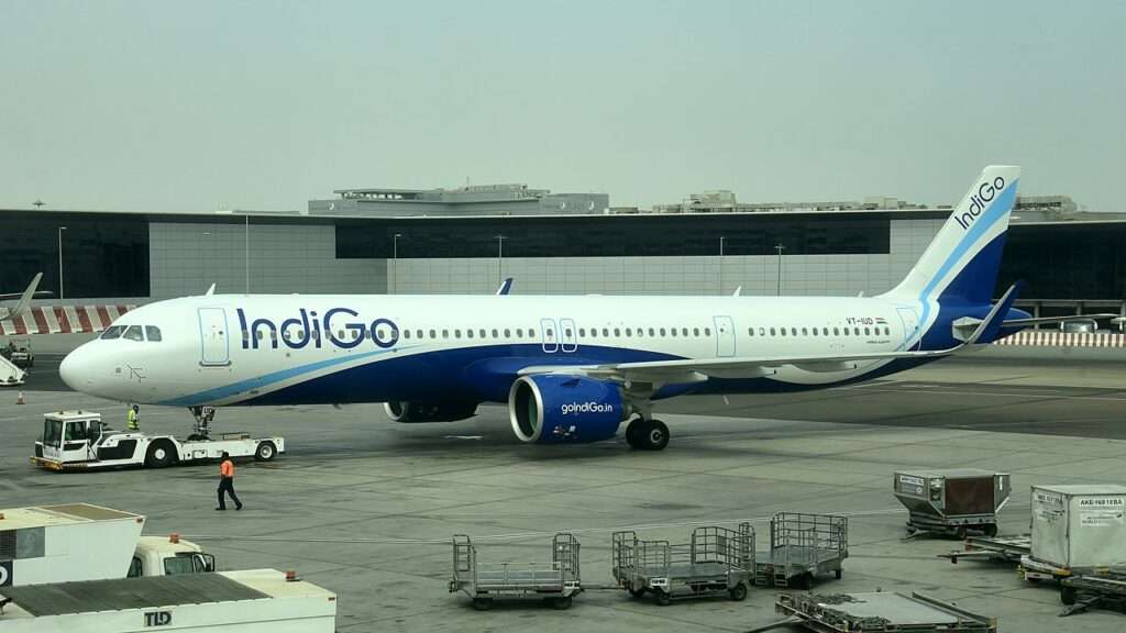 An IndiGo Airbus A321neo is towed by a tug.