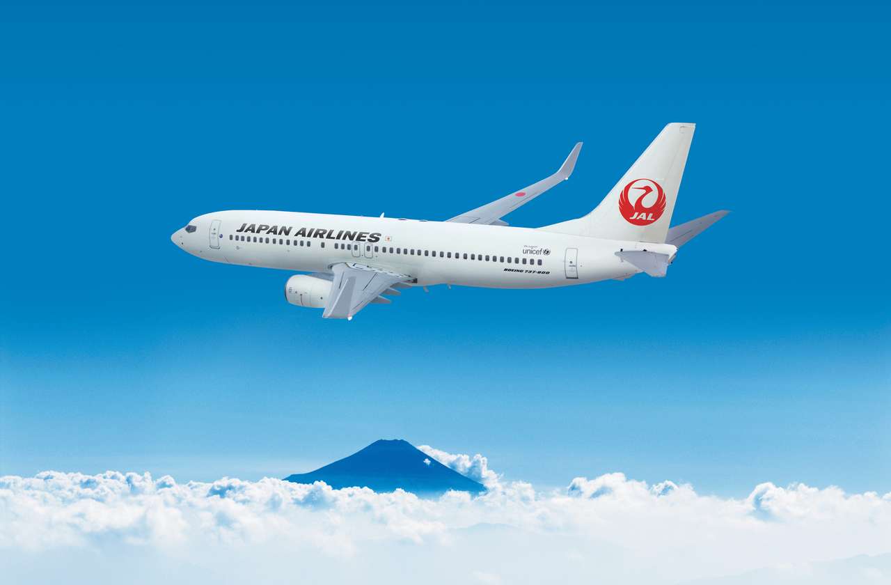 Render of a Japan Airlines Boeing above clouds