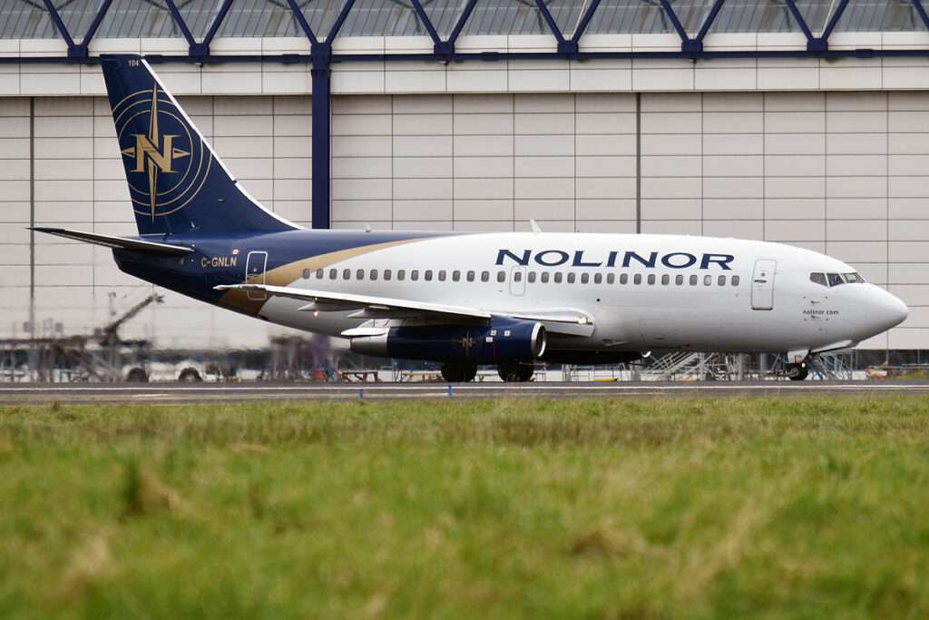 A Nolinor Aviation Boeing 737 in front of the hangar.