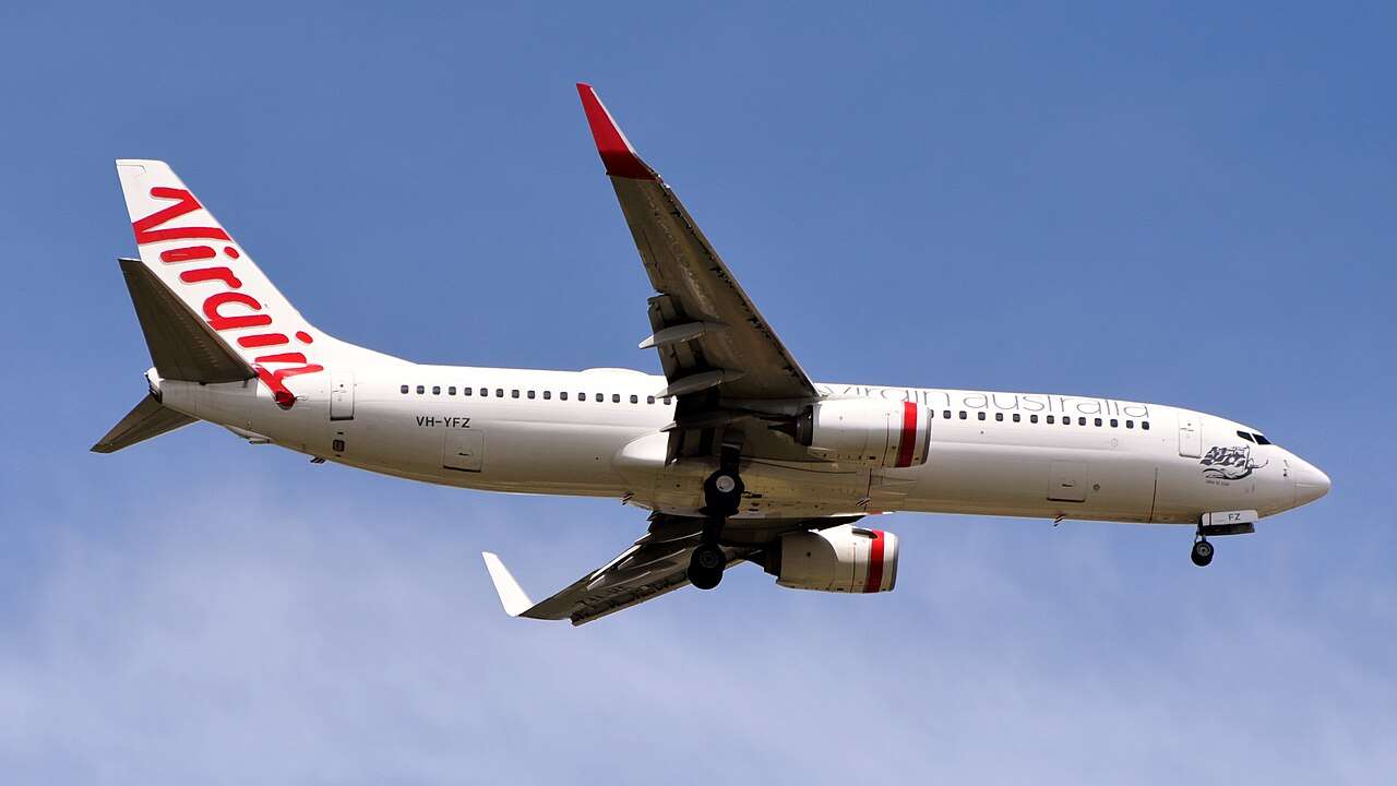 A Virgin Australia Boeing 737 passes overhead.