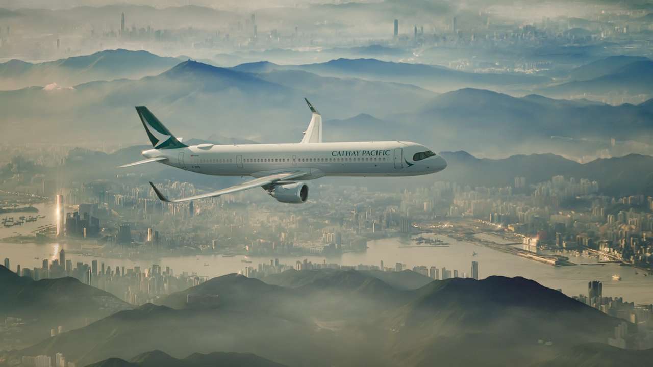 A Cathay Pacific A321 in flight over the city.