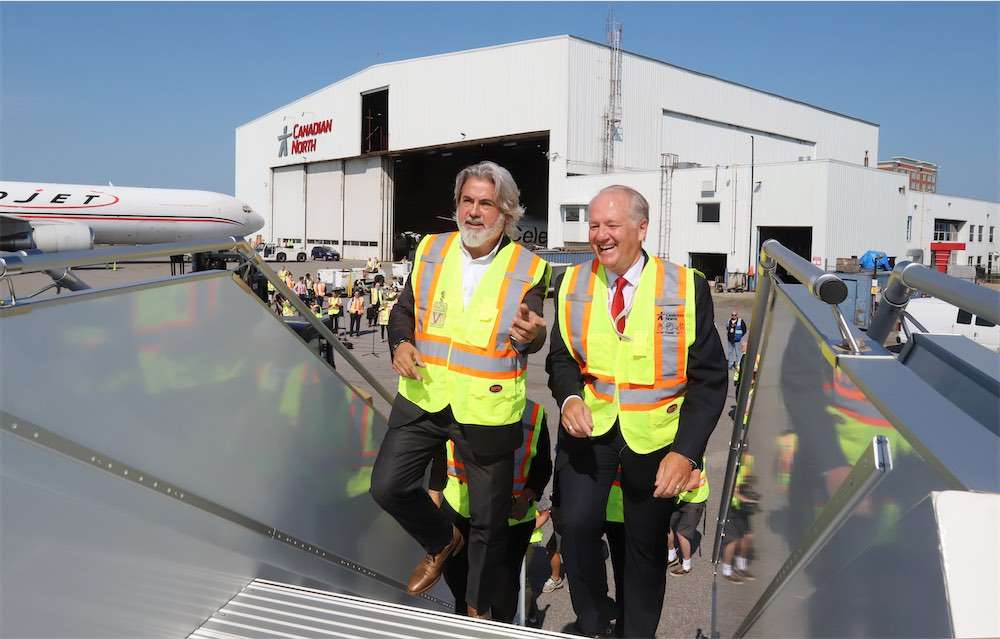 Minister of Trnsport and Canadian North CEO board a company aircraft.