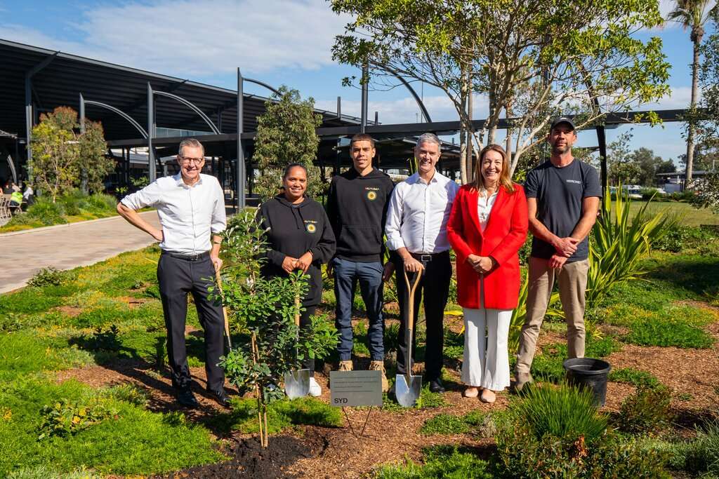 Personnel stand in front of the new Sydney Airport T1 forecourt.