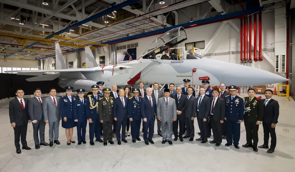 Indonesian and Boeing delegates with Boeing F15 fighter aircraft in hangar.