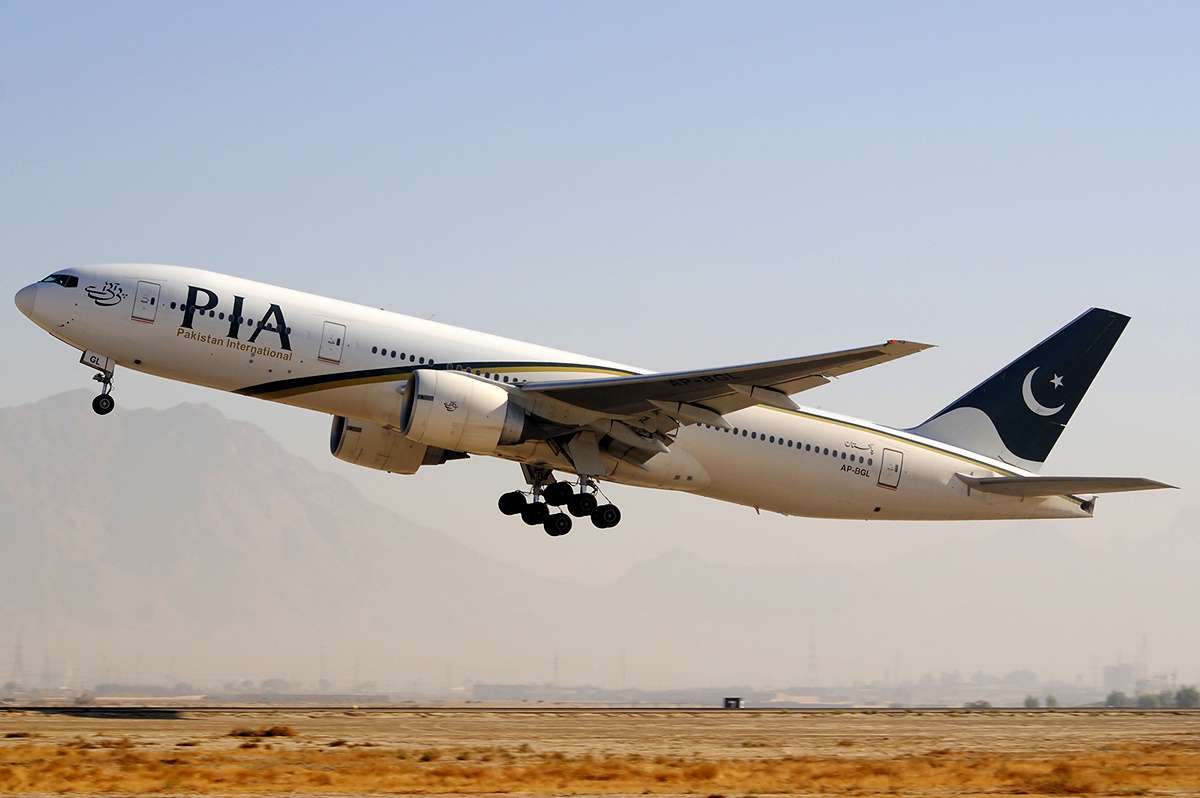 A PIA Boeing 777 climbs after takeoff.