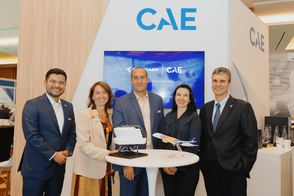 Embraer and CAE delegates sign service expansion agreement.