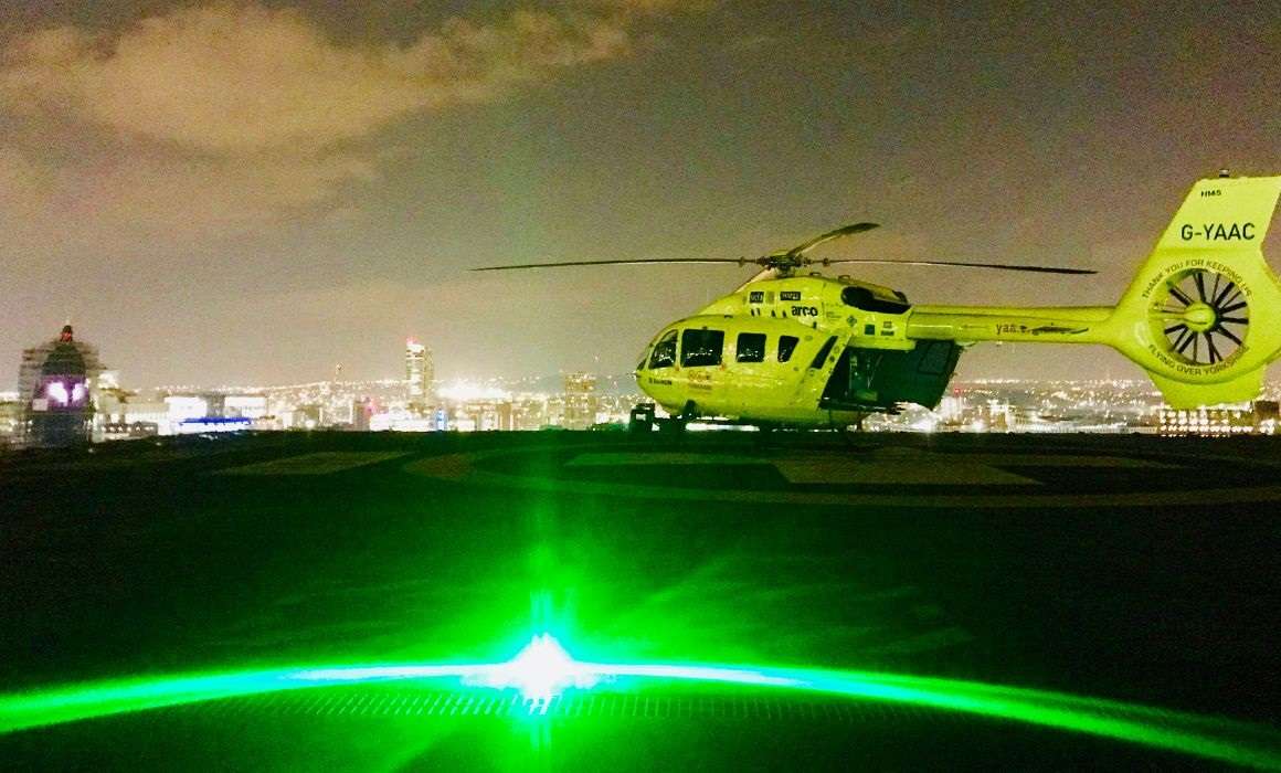 A Yorkshire Air Ambulance helicopter with green laser.
