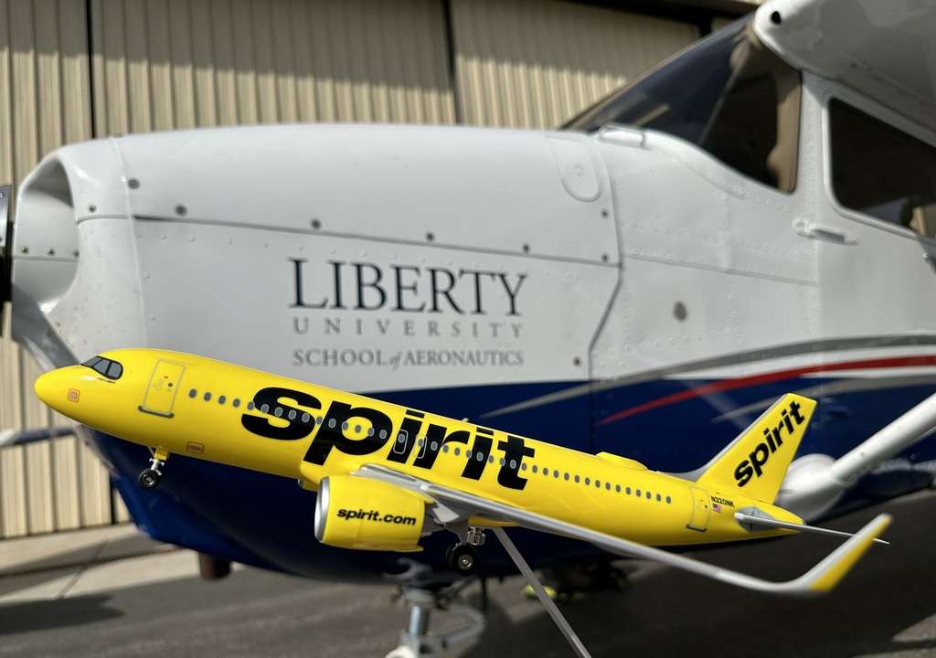 A Spirit Airlines model with a Liberty University Cessna 172.
