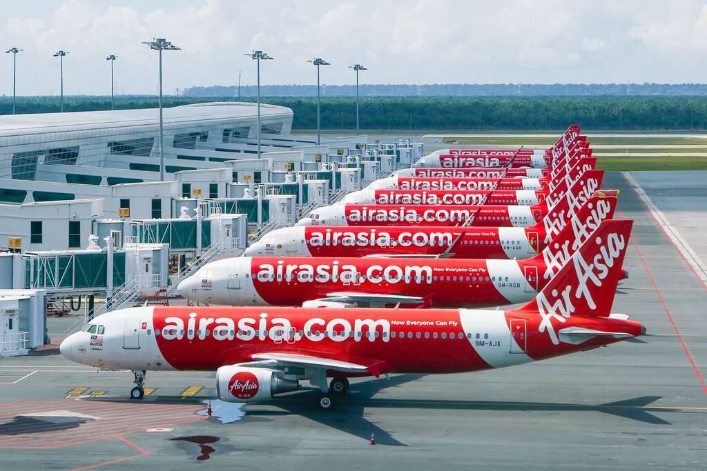 A line-up of parked AirAsia Airbus A320s.