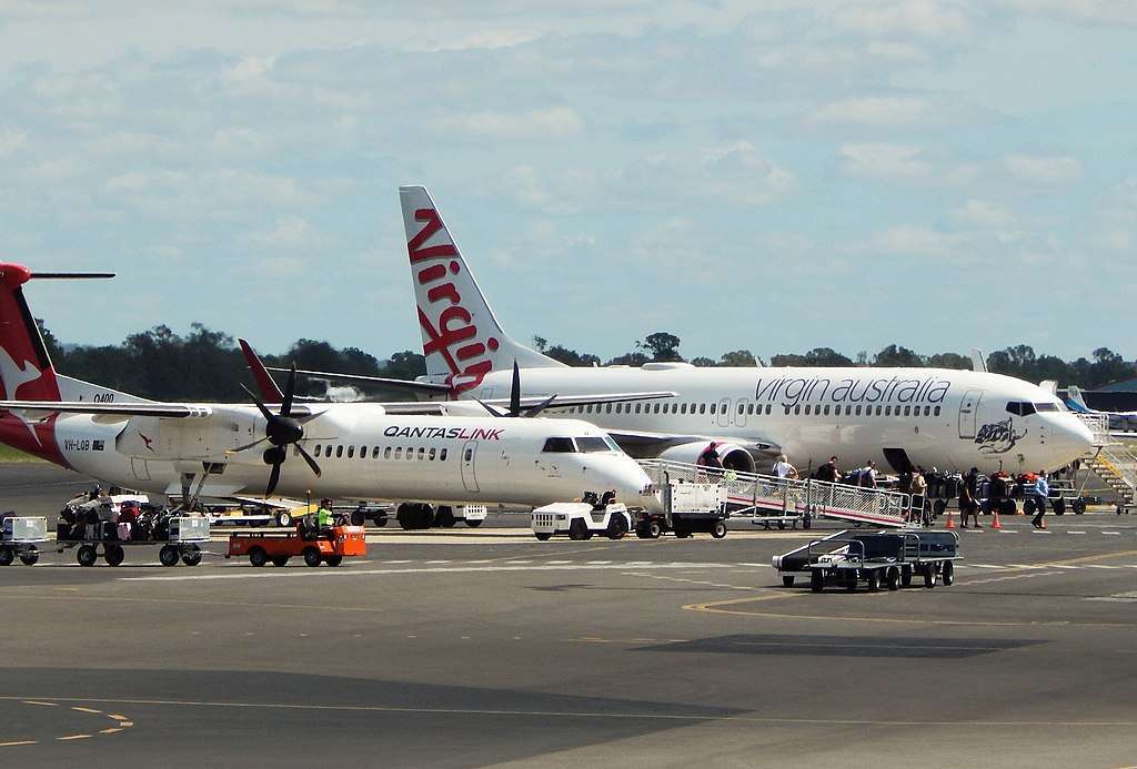 Qantaslink and Virgin Australia aircraft parked on the tarmac.