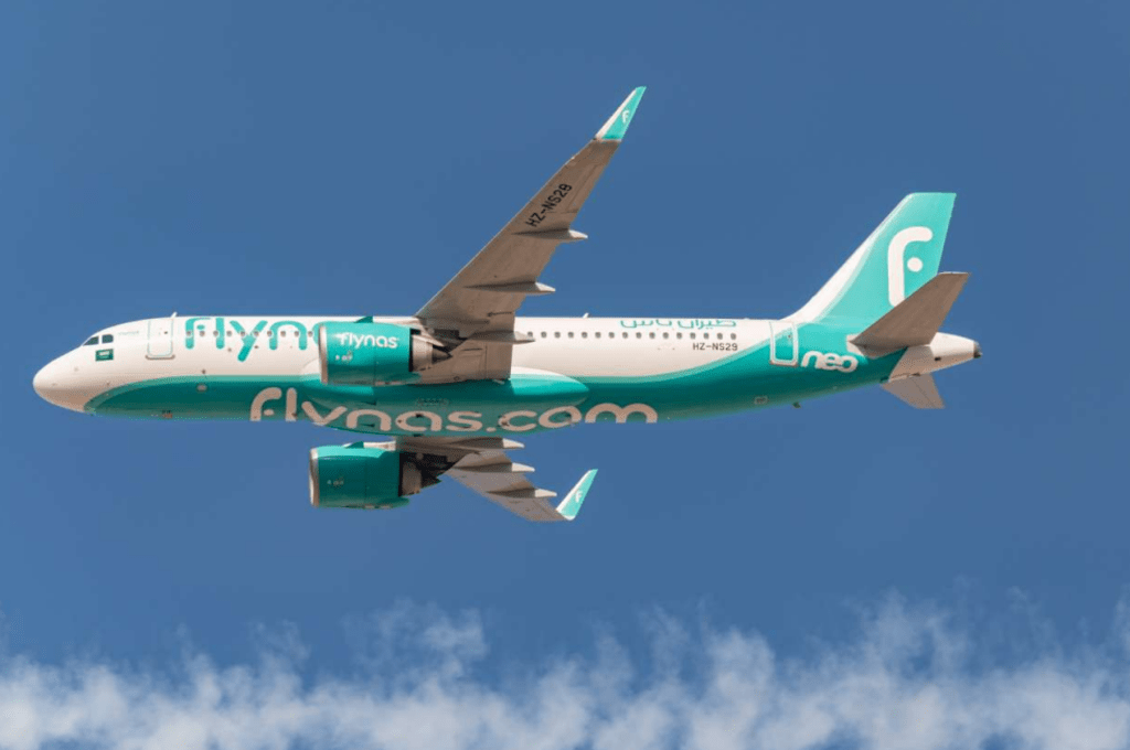 A flynas A320 passes overhead.