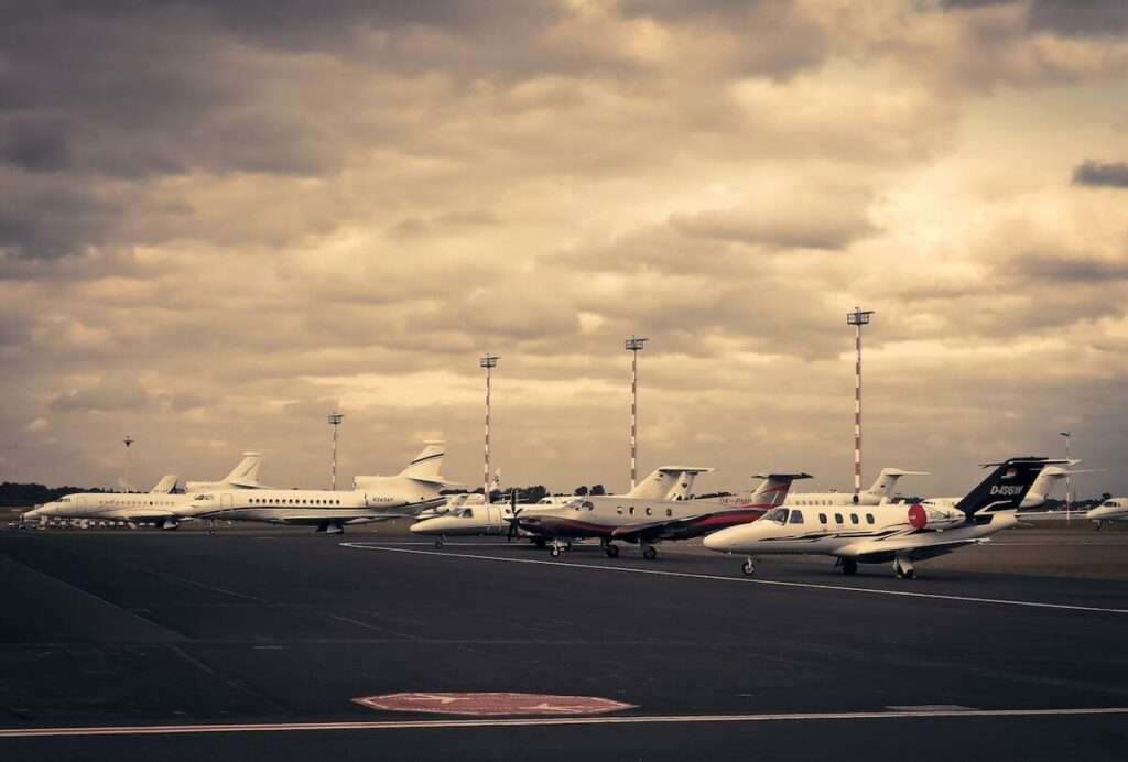 A group of private air charter jets on the tarmac.