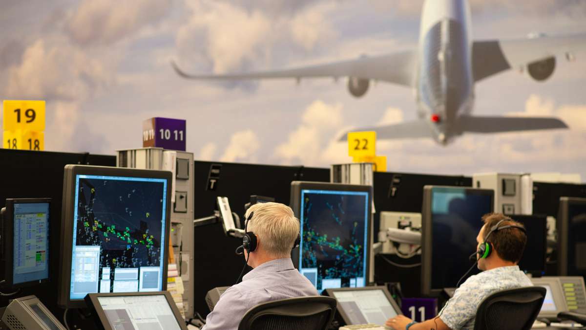 UK Air Traffic Controllers at monitors.