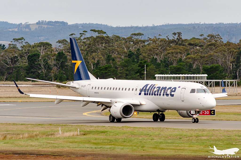 An Alliance Aviation Embraer E190 lines up on the runway.