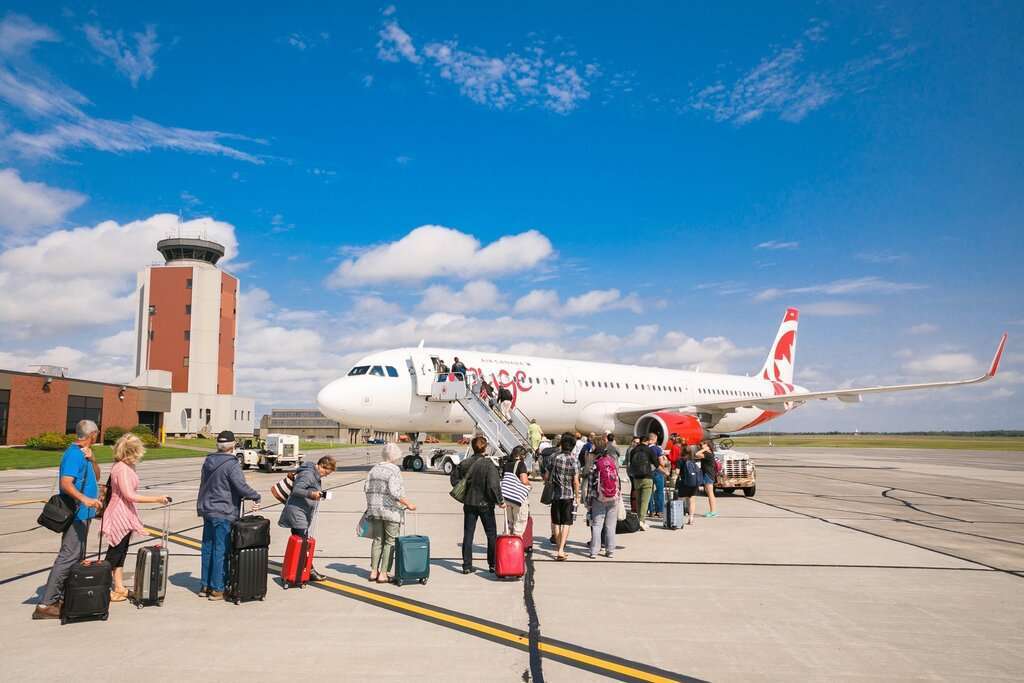 Passengers board an aircraft at Charlottetown Airport .