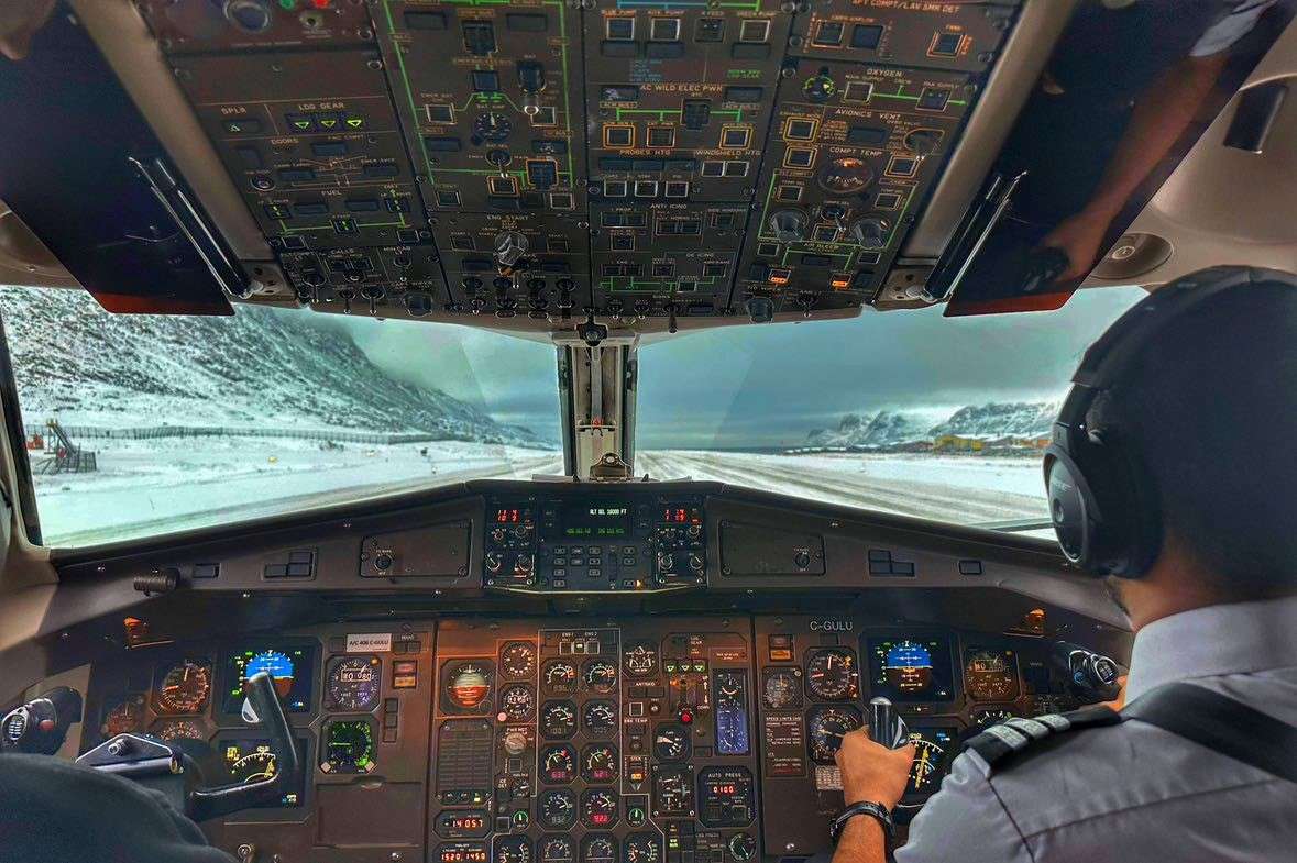 Cockpit view from a Canadian North jet on an icy runway.
