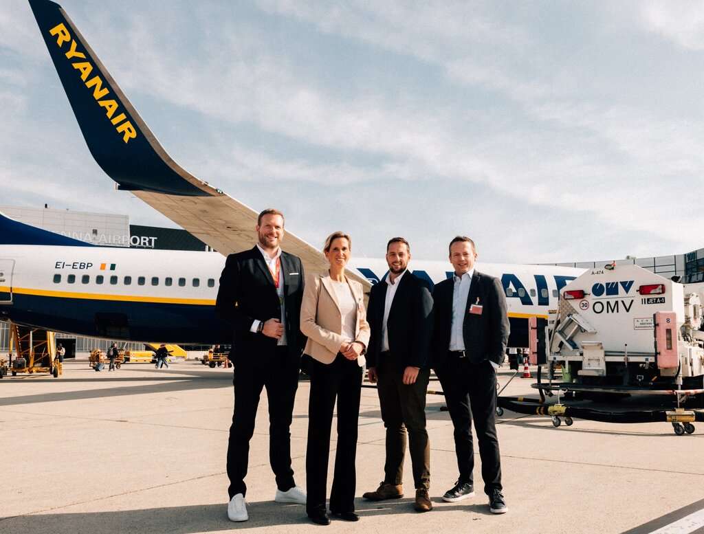Ryanair and OMV delegates with aircraft on tarmac.