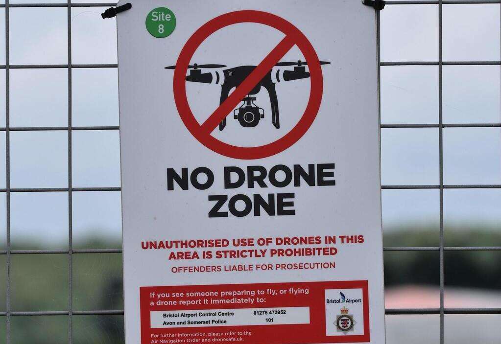 A 'No Drone' sign on airport fence.