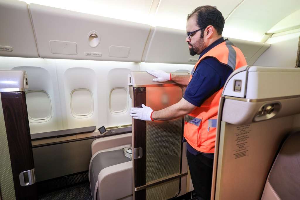 A Saudia Technic engineer works on the First Suite interior of a Boeing 777.