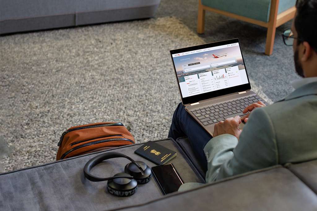 A passenger views Qantas business app on a laptop.