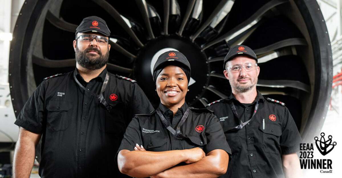 Air Canada staff in front of jet engine.