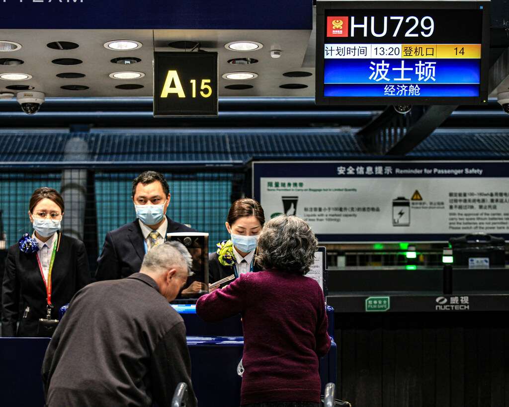 Passengers check in for Hainan Airlines flight from Beijing to Boston.