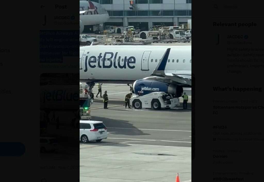 A JetBlue A321 jet showing impact with ground handling vehicle.